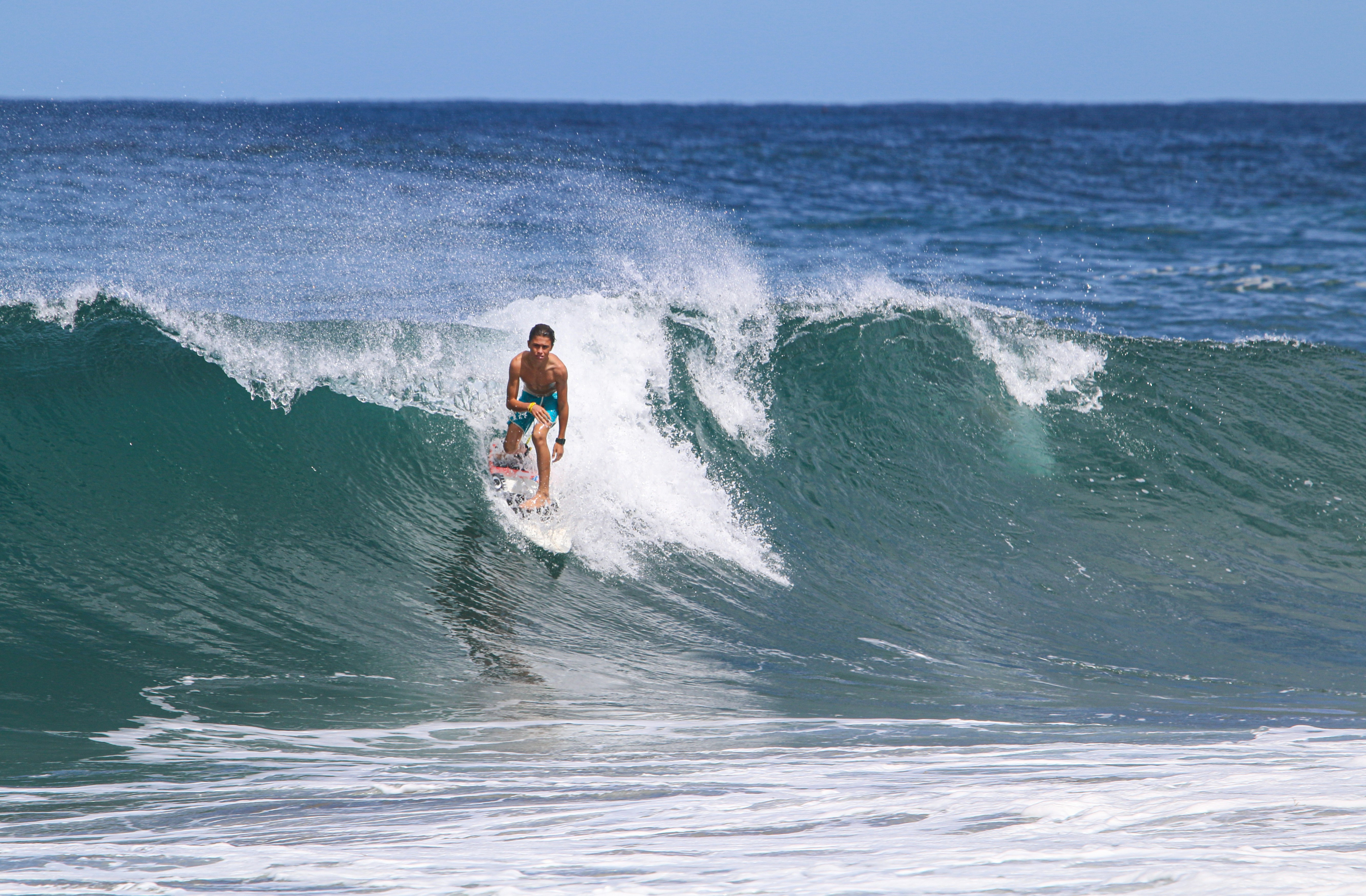 Surfer riding a large Atlantic wave in Portugal